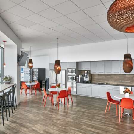 cafe style seating with orange chairs in 32 Old Slip